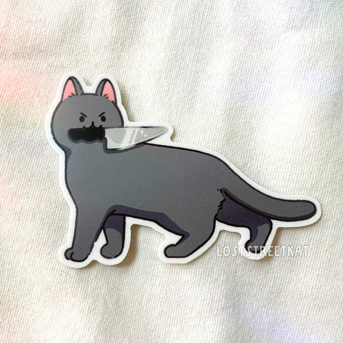 Grey cat with knife in mouth, looking backwards vinyl sticker